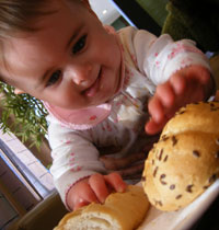 the munchkin digs into her rolls