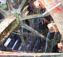 a close-up of the water wheel outside of locke's distillery in kilbeggan