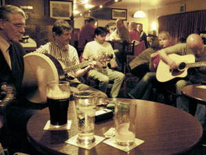 musicians gathered round the table at the weekly Green Olive pub session in athlone