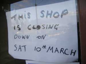 sign in the milltown mart window reading, "This shop will be closing down on 10th march"