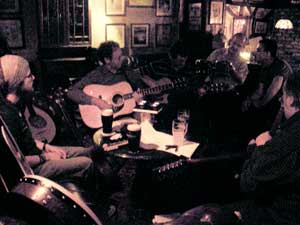 musicians gathered round the table at the weekly shack session in athlone