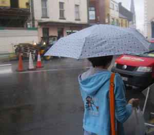 woman on church street in athlone in the rain