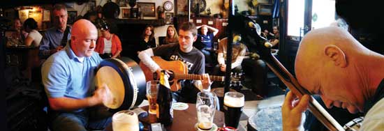 musicians gathered around the table at a traditional Irish session in Sean's Bar, Athlone