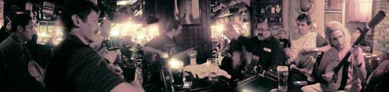 musicians gathered around the table at the shack session in athlone