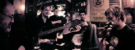 musicians gathered around the table at the shack session in athlone